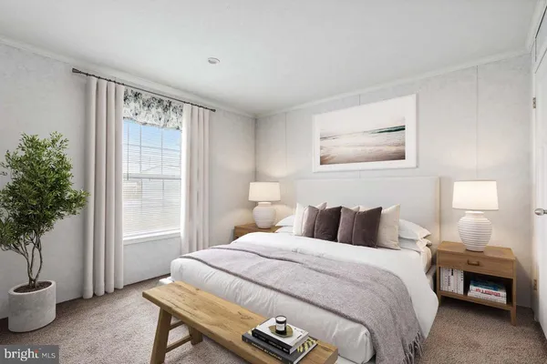 a bedroom with a large bed and a potted plant