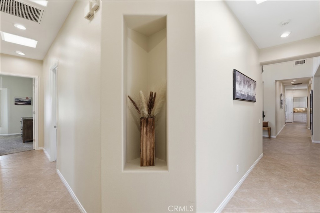 9 Orleans Road Rancho Mirage, CA 92270 - Photo 18 of 71 a view of a hallway with paintings on the wall