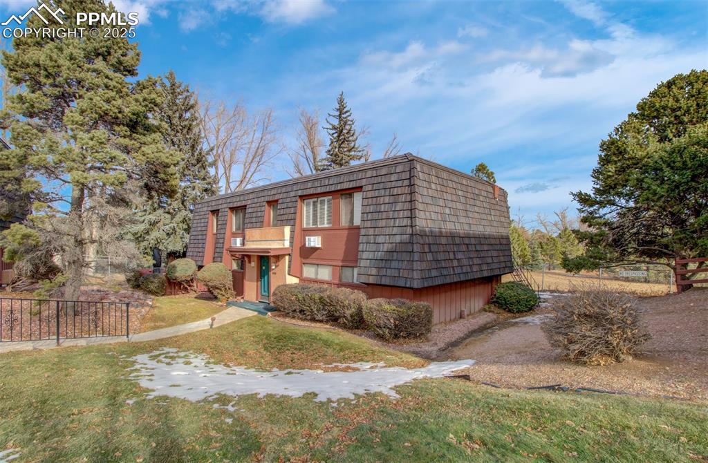 2959 Mesa Road, Unit C Colorado Springs, CO 80904 - Photo 1 of 17 a view of a house with a yard