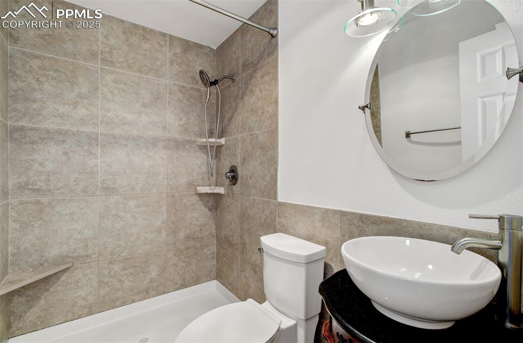 2959 Mesa Road, Unit C Colorado Springs, CO 80904 - Photo 11 of 17 a bathroom with a sink toilet and shower