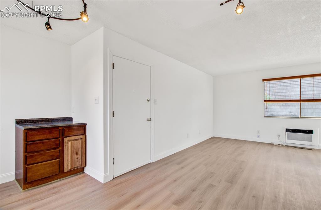 2959 Mesa Road, Unit C Colorado Springs, CO 80904 - Photo 13 of 17 a view of an empty room with wooden floor and a window