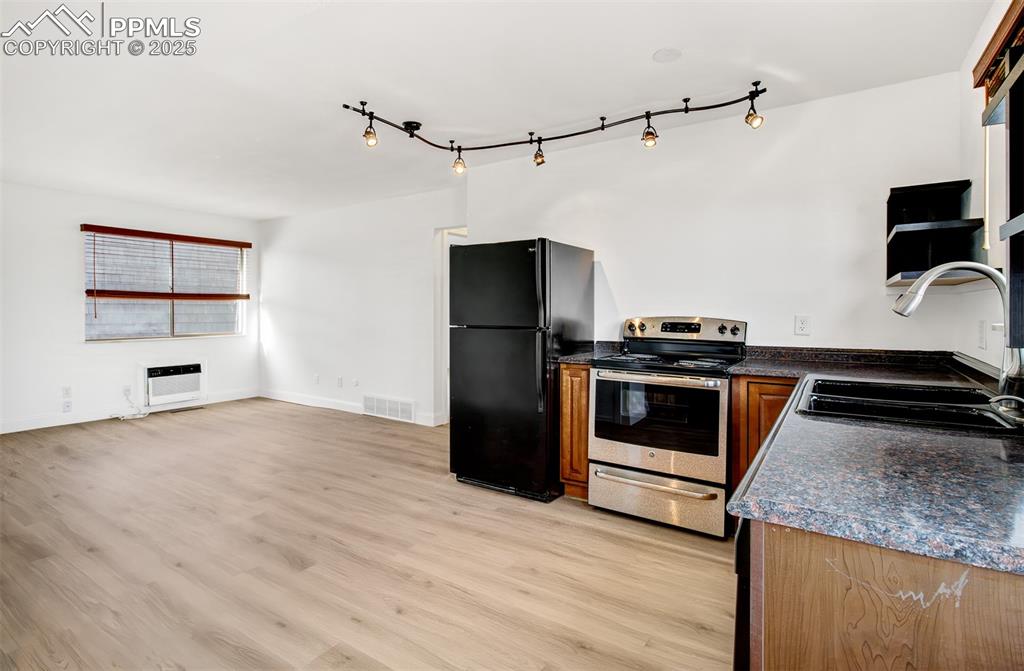2959 Mesa Road, Unit C Colorado Springs, CO 80904 - Photo 6 of 17 a kitchen with a stove and a refrigerator