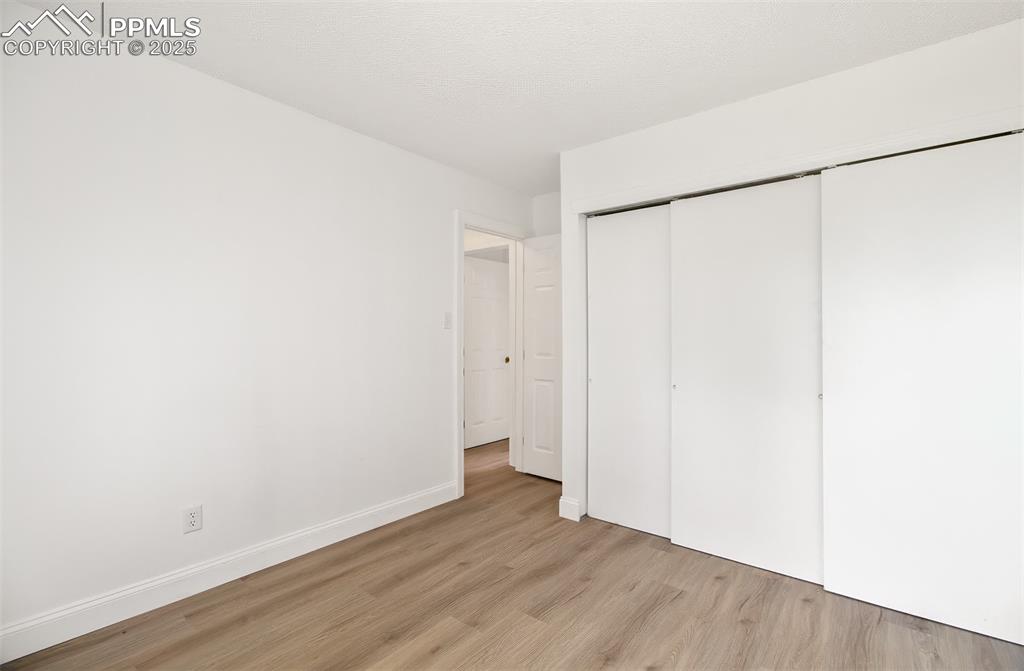 2959 Mesa Road, Unit C Colorado Springs, CO 80904 - Photo 10 of 17 a view of an empty room with wooden floor