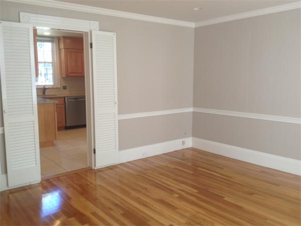 19 Brook Street, Unit 19 Wellesley, MA 02482 - Photo 7 of 13 a view of an empty room with wooden floor and a window