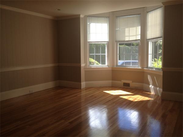 19 Brook Street, Unit 19 Wellesley, MA 02482 - Photo 8 of 13 a view of an empty room with wooden floor and a window