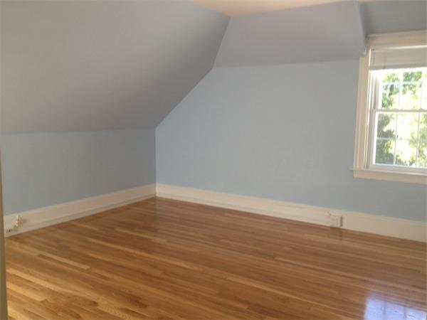 19 Brook Street, Unit 19 Wellesley, MA 02482 - Photo 10 of 13 a view of an empty room with wooden floor and a window