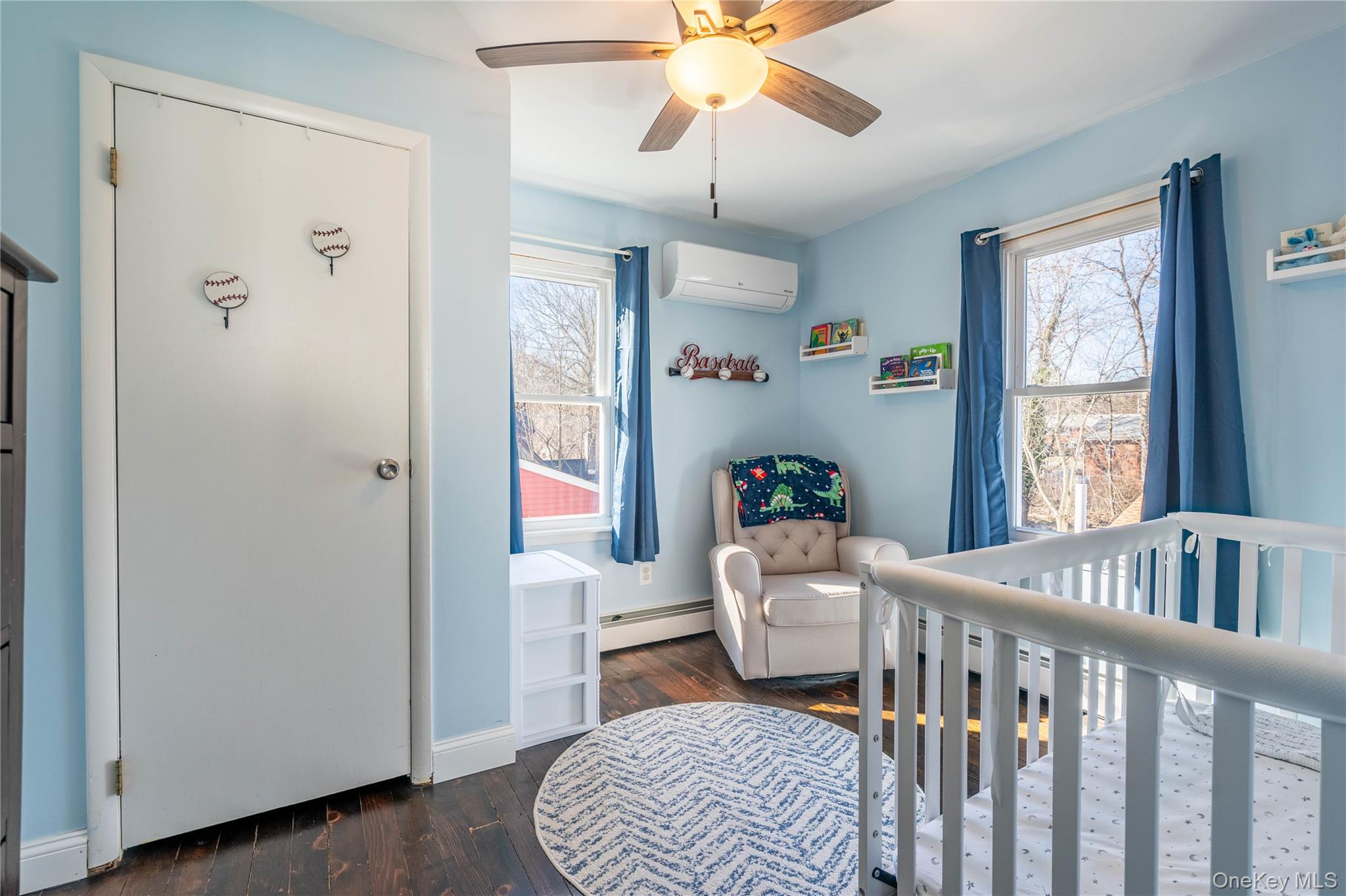 28 Maple Street Cornwall, NY 12518 - Photo 15 of 32 Bedroom featuring a nursery area, dark wood-style floors, an AC wall unit, a baseboard radiator, and ceiling fan