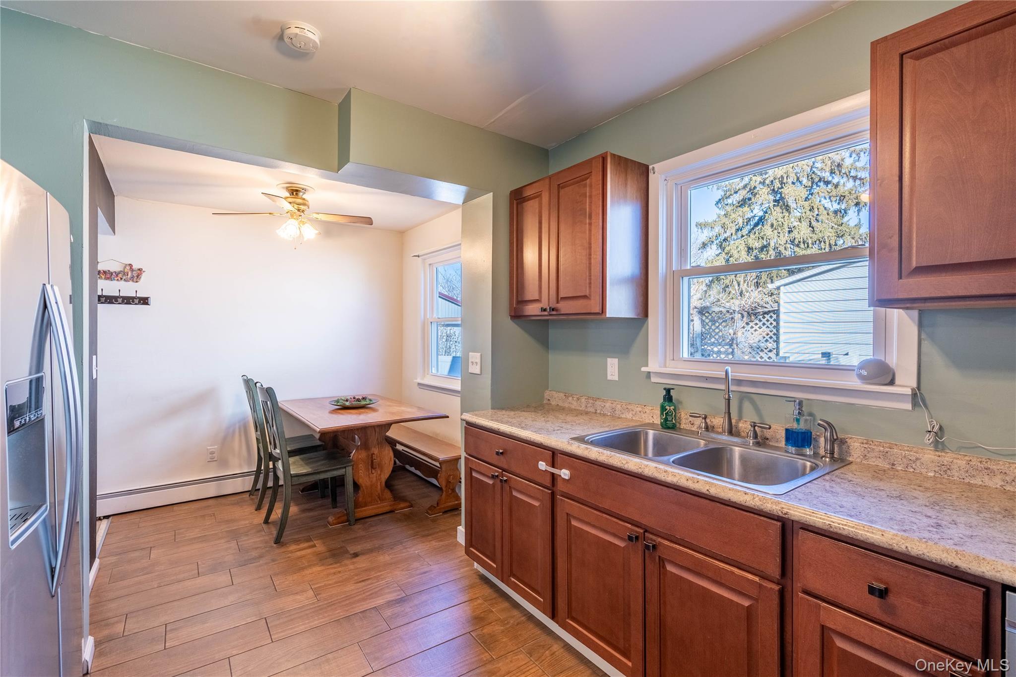 28 Maple Street Cornwall, NY 12518 - Photo 7 of 32 Kitchen with light countertops, stainless steel fridge, a ceiling fan, and dark wood-style floors