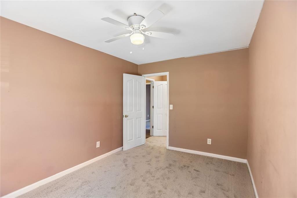 9720 Poole Road Villa Rica, GA 30180 - Photo 29 of 40 an empty room with a ceiling fan and window