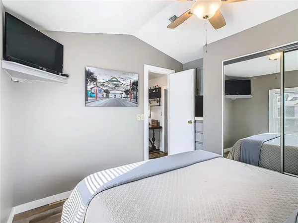 a bedroom with a bed and a flat screen tv