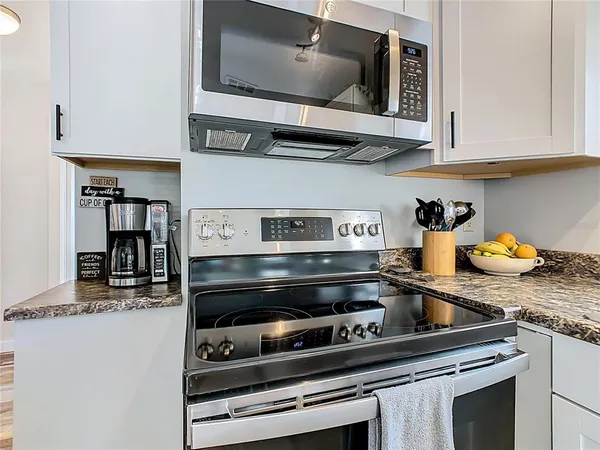 a kitchen with a stove and a microwave