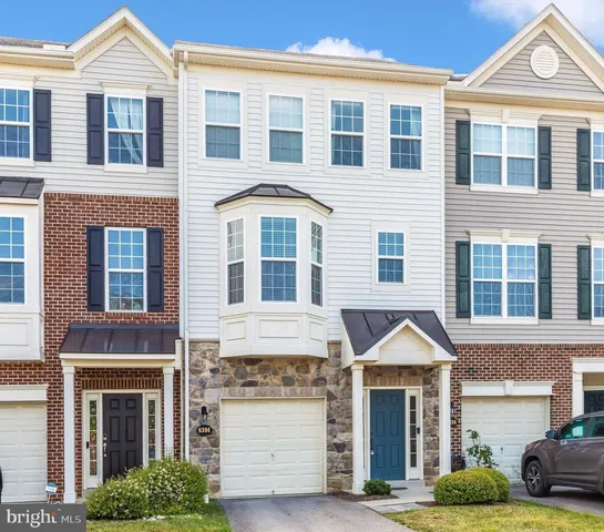 a front view of a residential houses with yard
