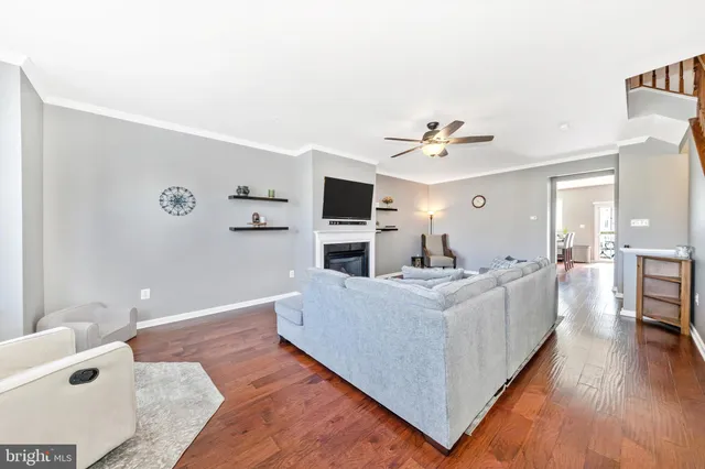 a kitchen with stainless steel appliances granite countertop wooden cabinets a stove a sink and a wooden floors