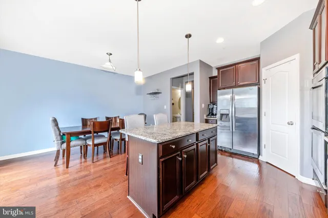 a kitchen with a refrigerator and a sink