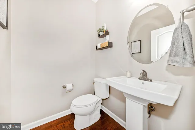 a spacious bedroom with a bed a dresser and a large window