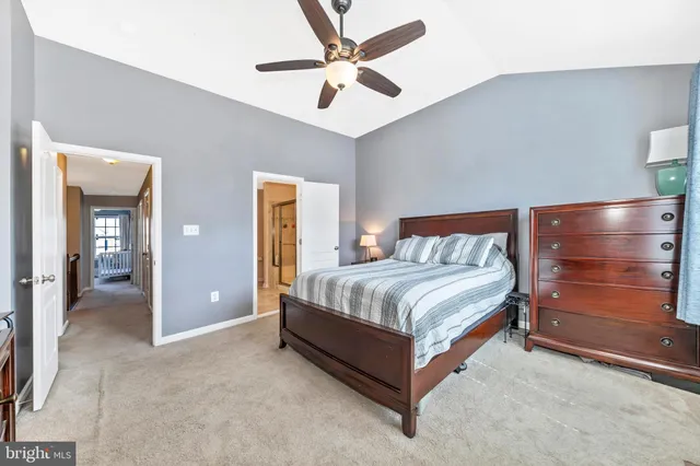 a spacious bedroom with a bed and a chandelier