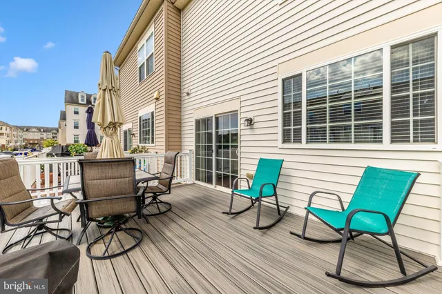 a backyard of a house with a bench and wooden floors