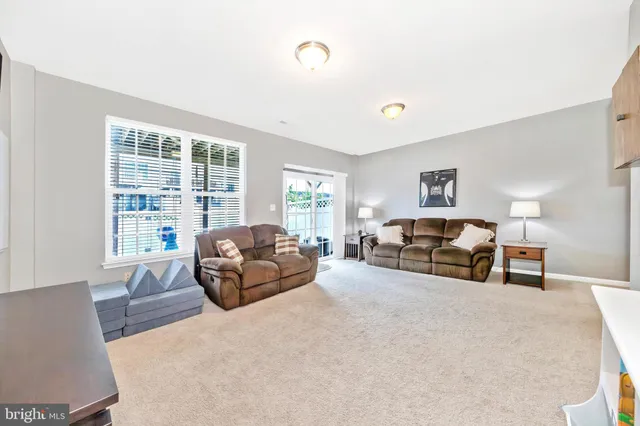 a living room with fireplace furniture and a flat screen tv