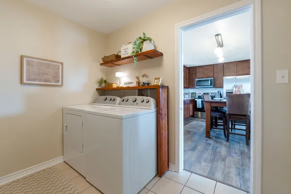 a view of kitchen with furniture and refrigerator