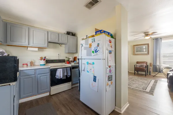 a kitchen with a refrigerator and a sink