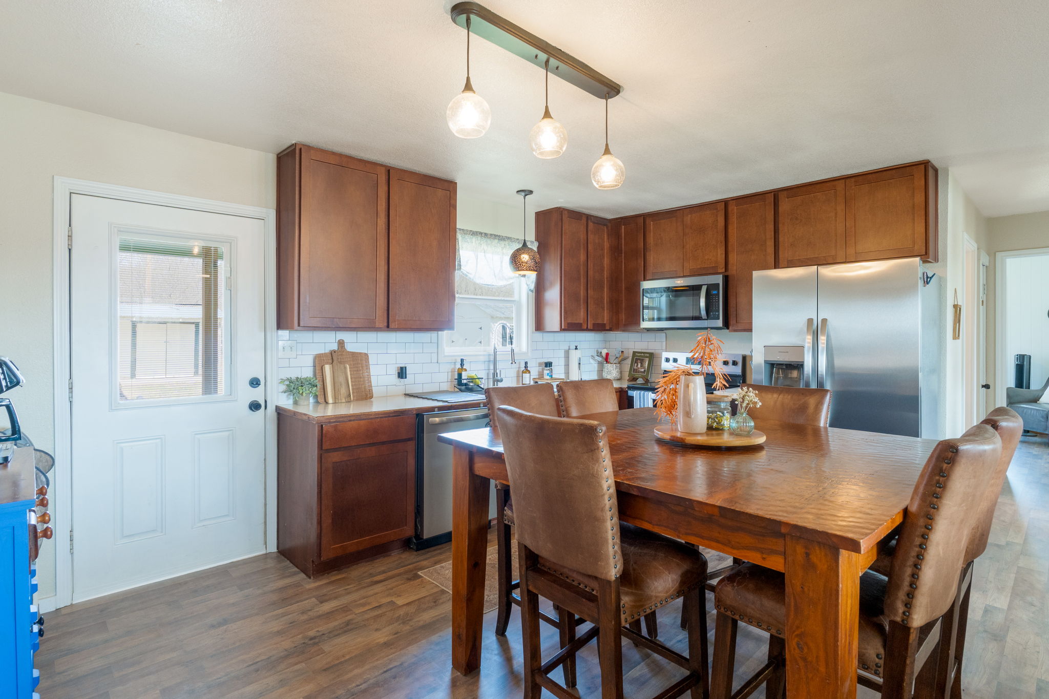6129 Farm To Market 2313 Kempner, TX 76539 - Photo 4 of 28 a kitchen with stainless steel appliances granite countertop a kitchen island a stove a refrigerator a sink a dining table and chairs with wooden floor