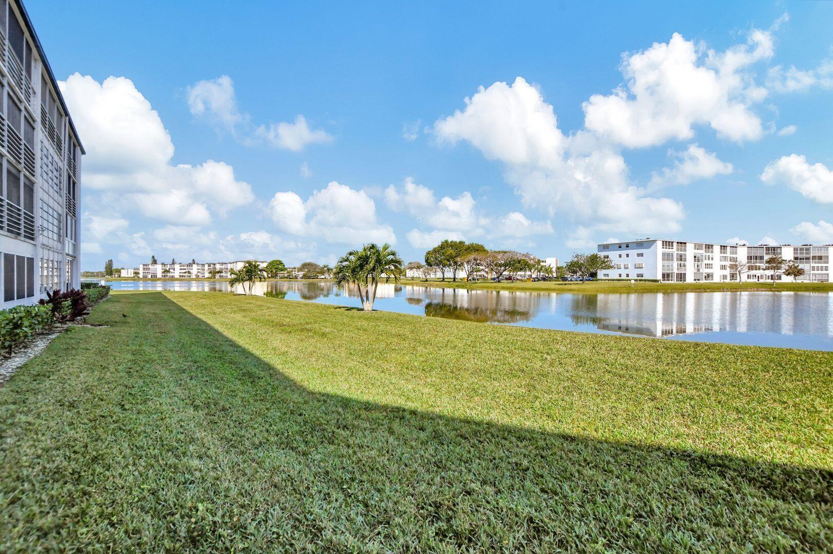 1047 Exeter C Boca Raton, FL 33434 - Photo 15 of 37 a view of a lake with houses in the back