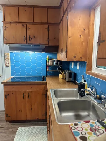 a kitchen with stainless steel appliances granite countertop a sink a stove and a microwave oven