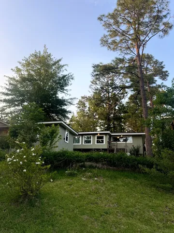 a view of house with a yard