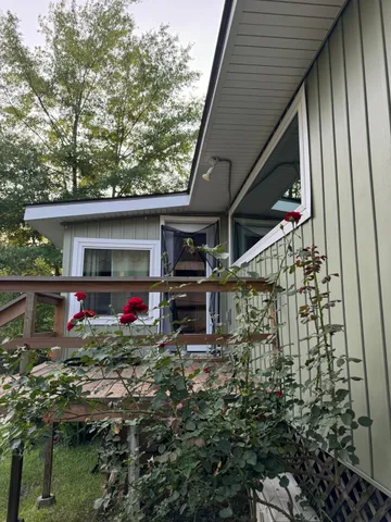 a view of a house with a sitting area and garden