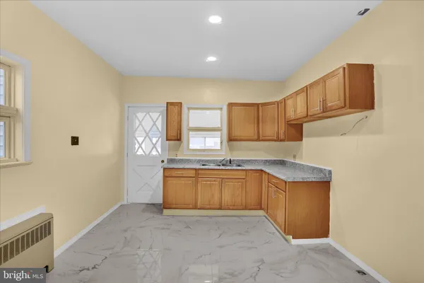 a kitchen with granite countertop a sink and cabinets