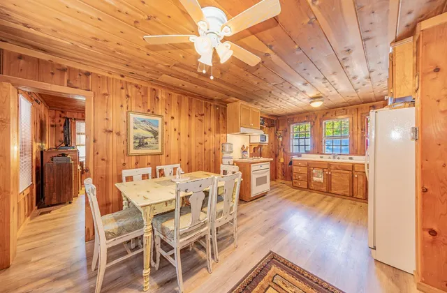 a dining room with furniture and wooden floor