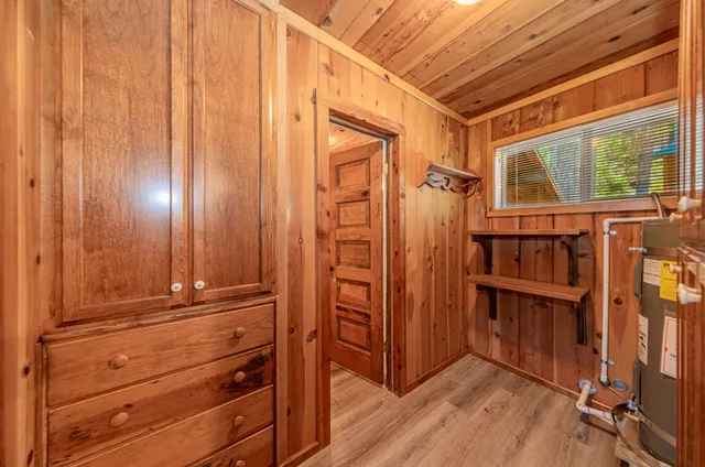 a view of a closet area with wooden floor