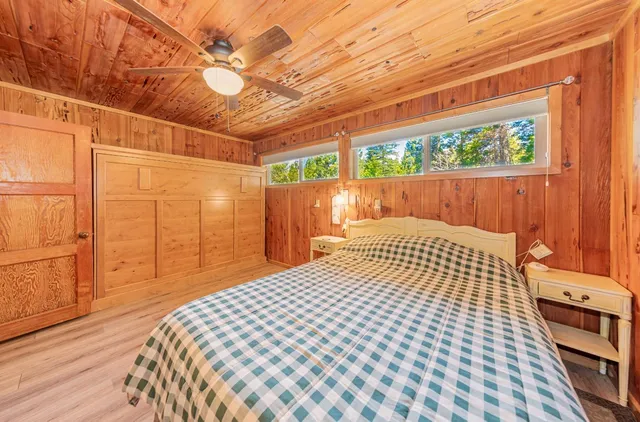 a bedroom with a bed and a wooden floor