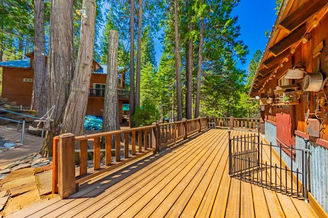 a view of balcony with wooden floor and fence
