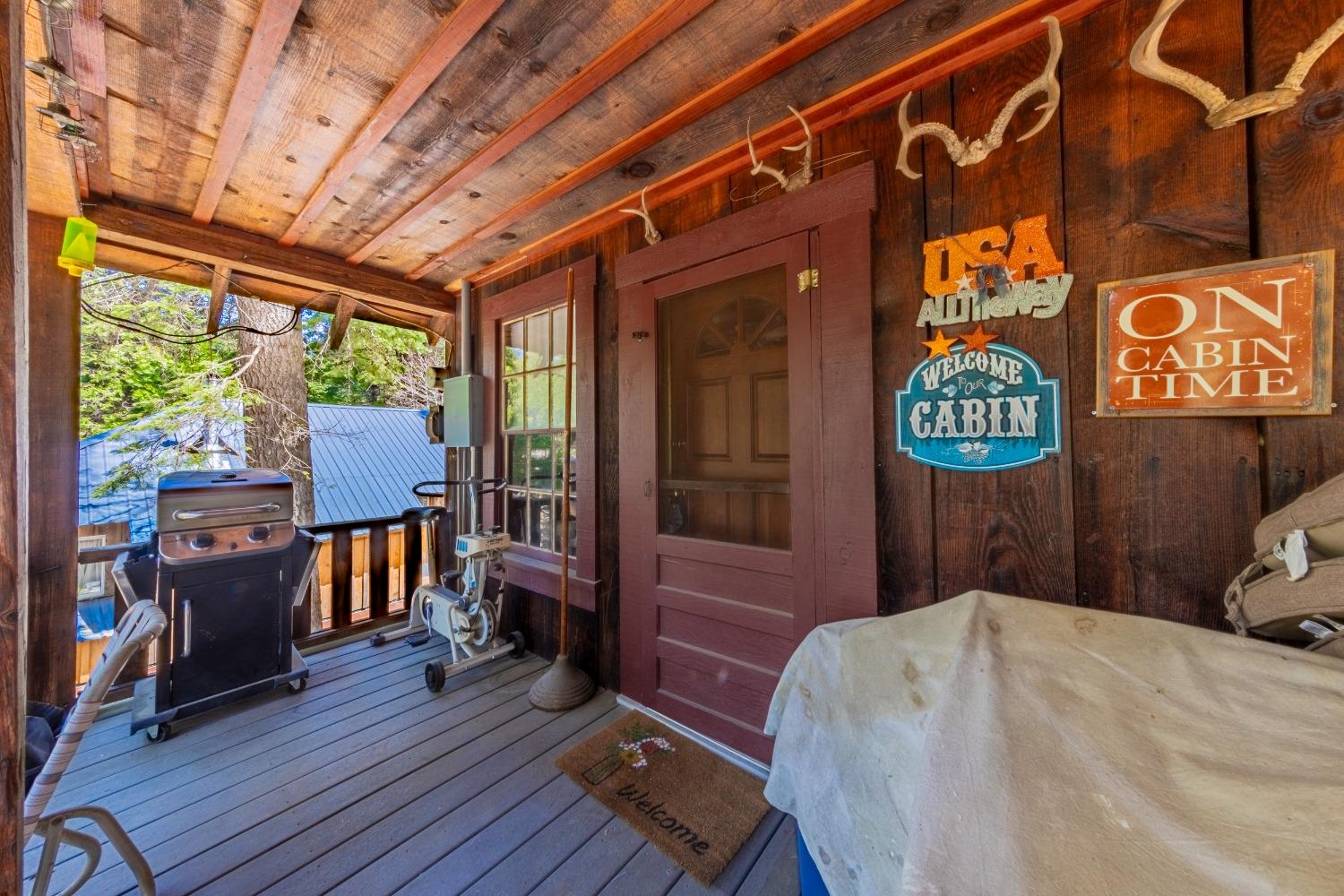 50054 Poplar Road Oakhurst, CA 93644 - Photo 23 of 34 a bedroom with a bed and wooden floor