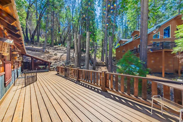 a view of balcony with wooden floor and fence