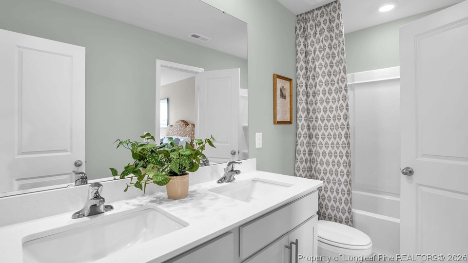 386 Hartfield Avenue Raeford, NC 28376 - Photo 29 of 32 a bathroom with a sink toilet and shower