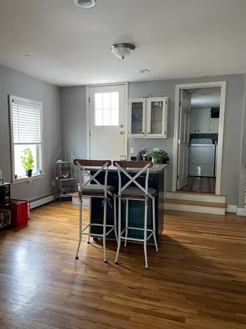 a view of a dining room with furniture window and wooden floor