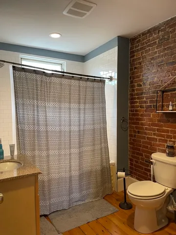 a bathroom with a shower curtain and sink