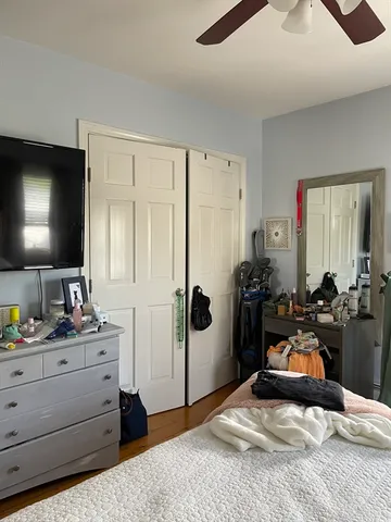 a bedroom with a bed and a dresser in it