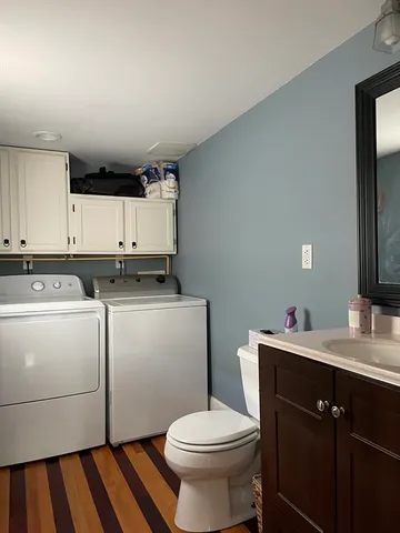 a bathroom with a sink toilet and mirror