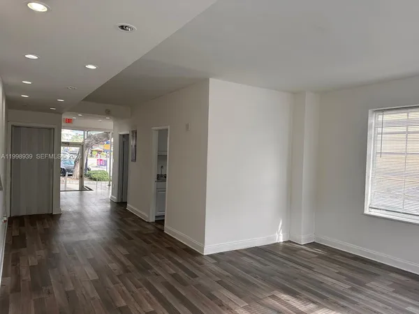 a view of an entryway with wooden floor