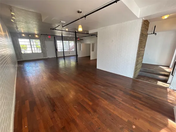a living room with furniture a flat screen tv and a window