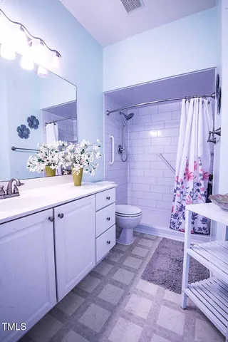 a bathroom with a sink mirror and vanity