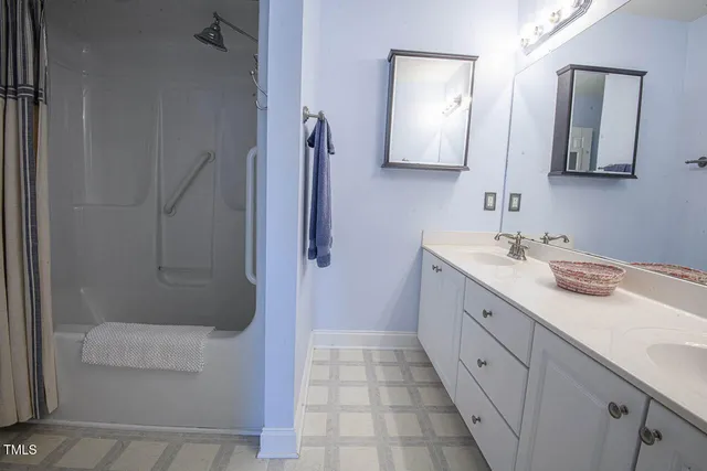 a bathroom with a double vanity sink and mirror