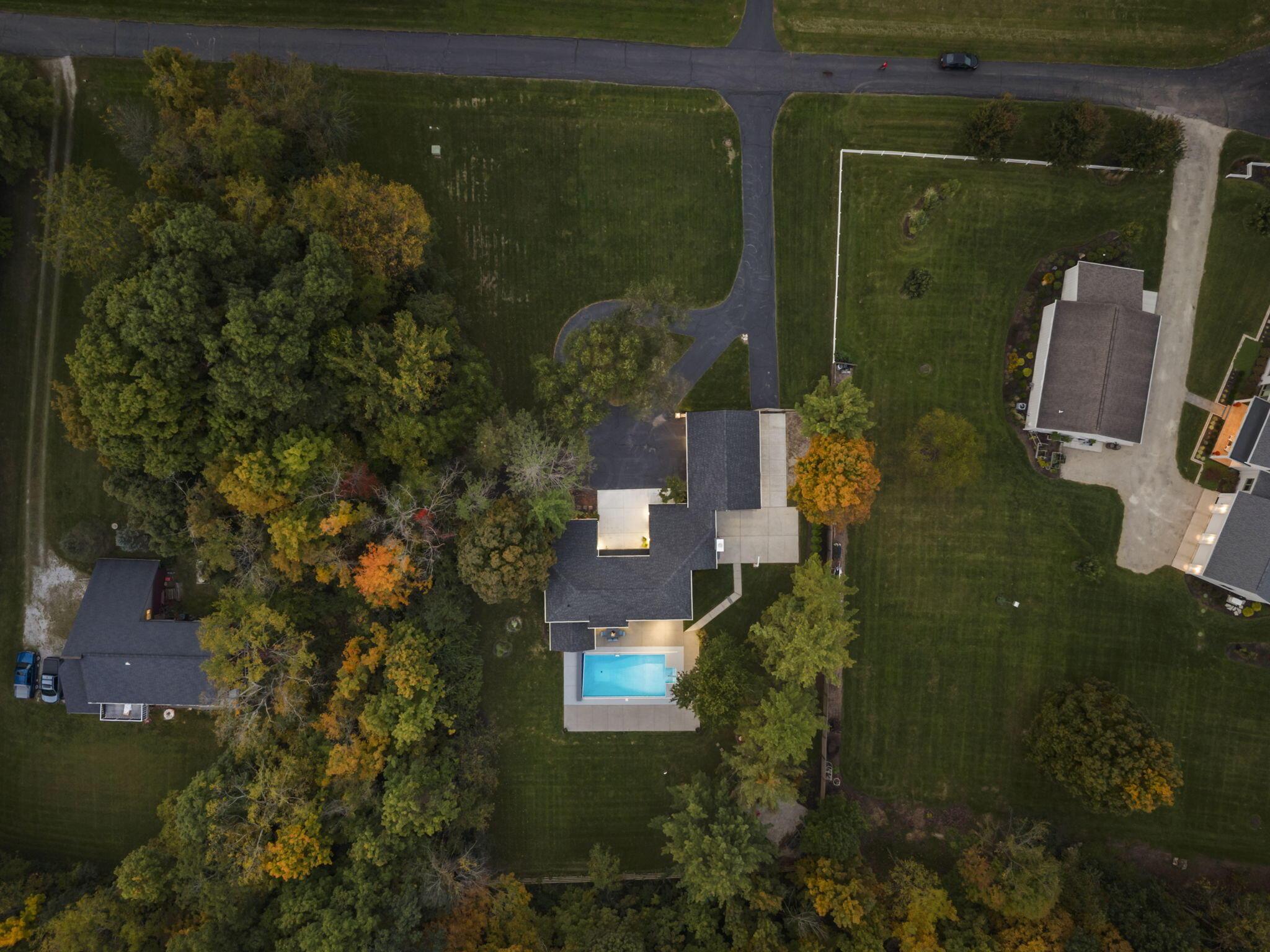 7140 Cook Road Powell, OH 43065 - Photo 14 of 87 Expansive property with a private swimming pool, mature perimeter trees, a paved circular driveway, and an attached garage