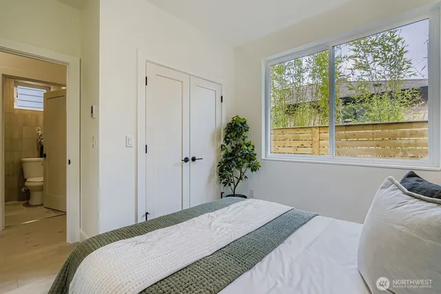 a bedroom with a bed and a window