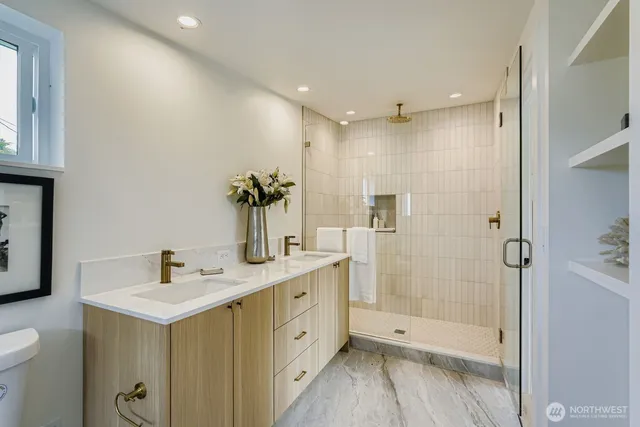 a bathroom with a shower sink and mirror