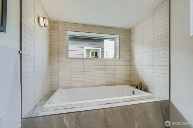 a bath tub sitting next to a white sink