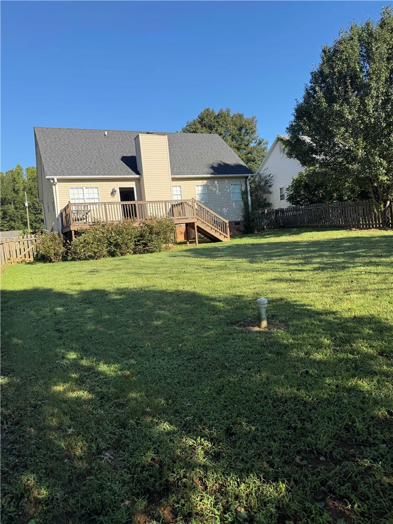 116 Kelly Lane Easley, SC 29642 - Photo 38 of 39 An elevated wooden deck overlooks the large grassy backyard enclosed by privacy fencing.